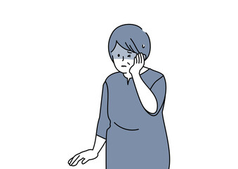 頬をおさえるシニア