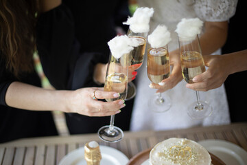 Girls hold glasses of wine. Party details. Wedding celebration.