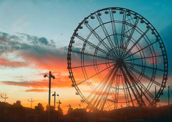 Beautiful large Ferris wheel outdoors at sunset