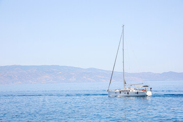 Fototapeta premium Beautiful seascape with sailboat and distant shore