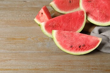 Delicious fresh watermelon slices on wooden table. Space for text