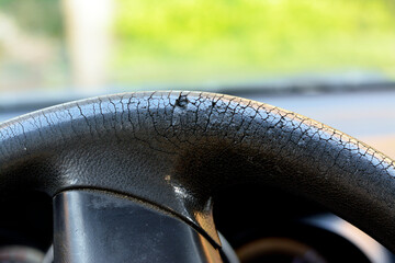 Selective focus of cracks and damaged rubber of the car steering wheel due to long exposure to the...