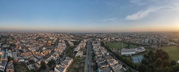 A beautiful aerial panorama of the rising sun over a housing society and its sports ground in Lahore, Pakistan. 