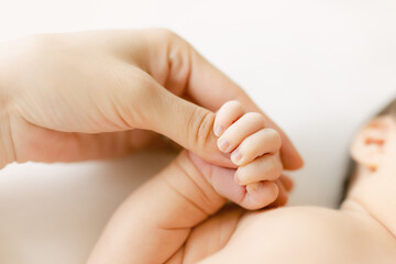 newborn baby and mom's hand 