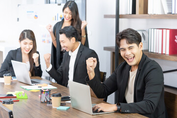 Yes! Businesspeople triumphing because of the financial growth of company. Happy smiling businesspeople triumphing with raised fists.