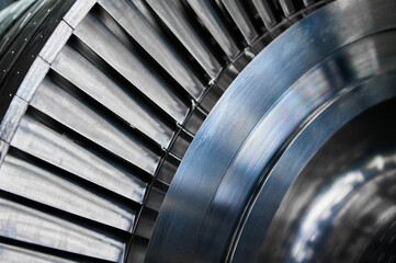 Shiny blades of high-speed steam turbine in workshop