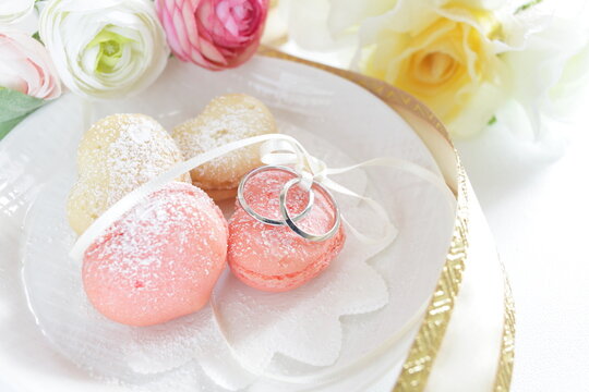 French confectionery, heart shaped Macaroon and wedding rings for marriage image