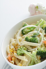 Homemade short pasta and broccoli salad with onion and carrot