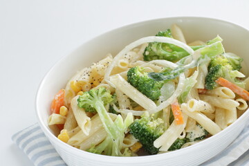Homemade short pasta and broccoli salad with onion and carrot