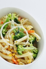 Homemade short pasta and broccoli salad with onion and carrot