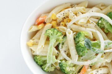 Homemade short pasta and broccoli salad with onion and carrot