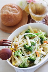 Homemade broccoli and short pasta salad with onion and carrot