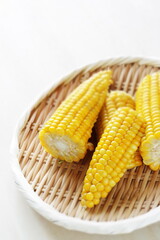 Boiled Japanese sweet corn on bamboo basket with copy space for summer food image