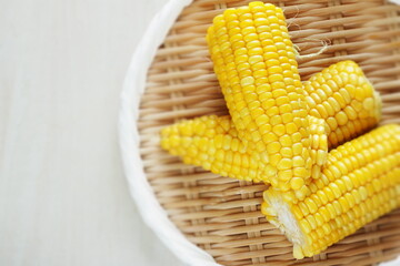 Boiled Japanese sweet corn on bamboo basket with copy space for summer food image