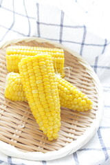 Boiled Japanese sweet corn on bamboo basket with copy space for summer food image
