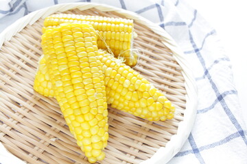 Boiled Japanese sweet corn on bamboo basket with copy space for summer food image