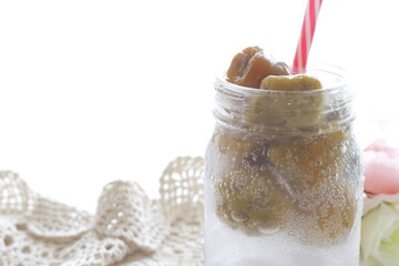 Plum wine soda in jar bottle with straw