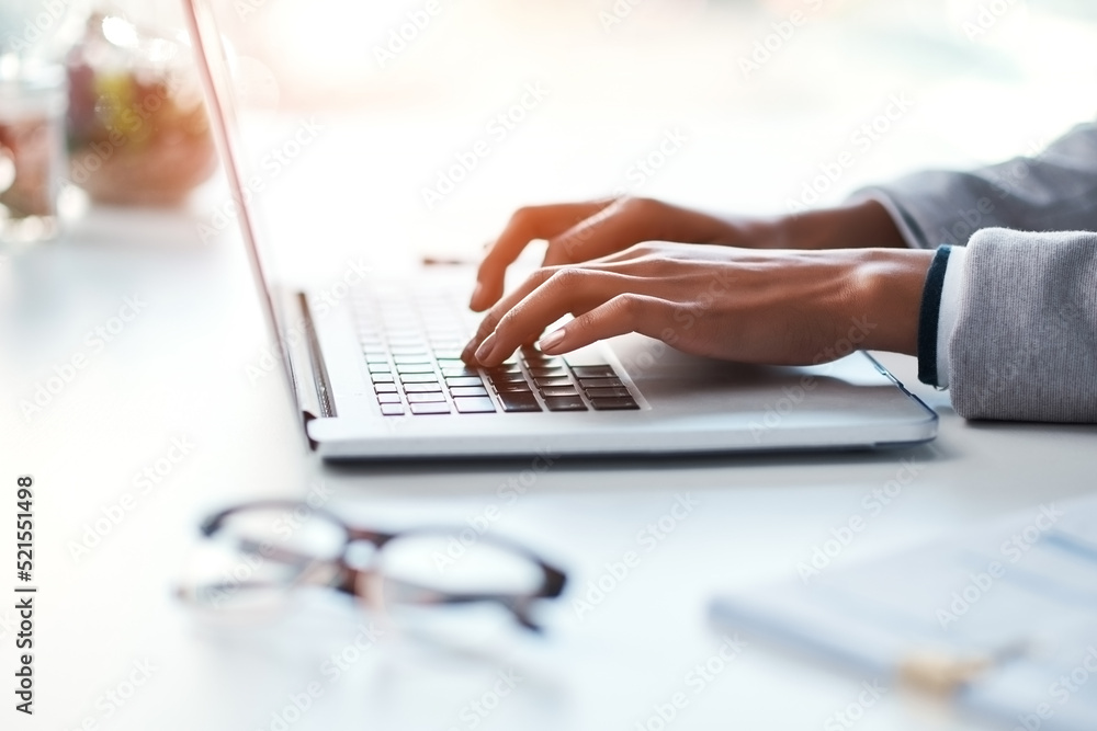Poster businesswoman typing work on a laptop at her desk in a modern office. busy female doing business on 