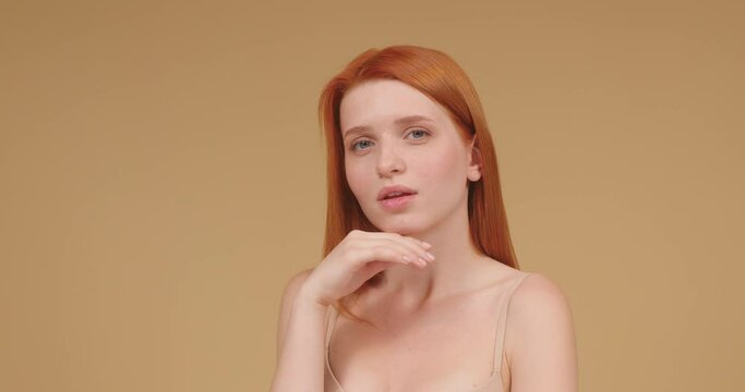 Young woman demonstrates well-cared appearance smiling