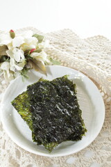 Korean food, sesame oil seaweed sheet on white dish © jreika