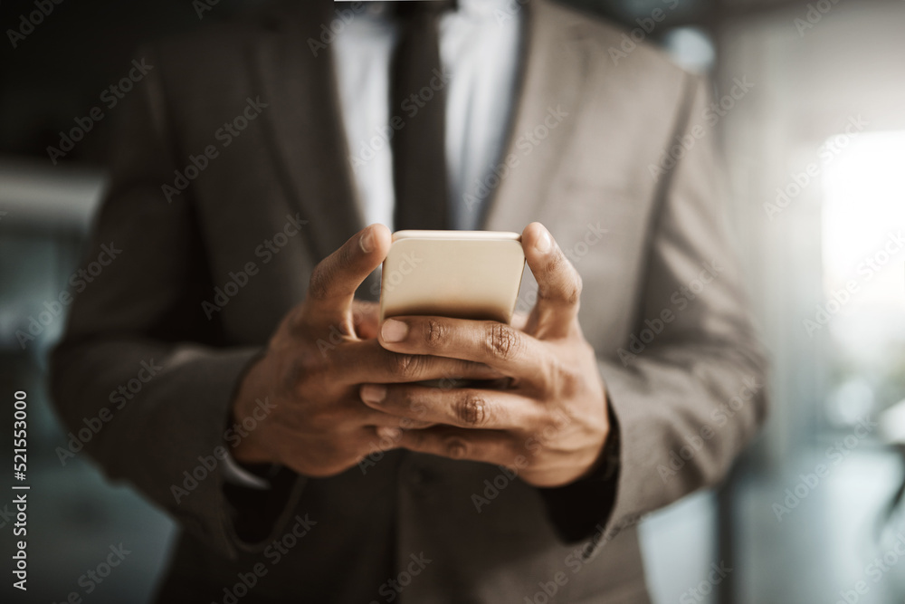 Poster businessman texting on a phone to send a formal business sms text inside an office at work. african 