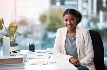 Young, confident and ambitious business woman and corporate professional looking happy, positive and smiling in her office at work. Portrait of a female creative designer sitting at her desk - Powered by Adobe