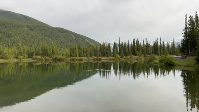 Forget-me-not Pond in Kananaskis Country by Calgary, Alberta. A peaceful, serene landscape with a stunning reflection of the surrounding mountains. 