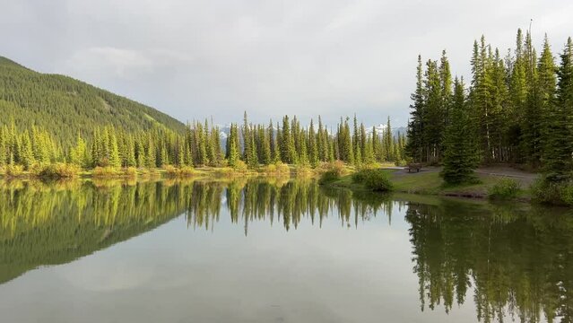 Forget-me-not Pond in Kananaskis Country by Calgary, Alberta. A peaceful, serene landscape with a stunning reflection of the surrounding mountains. 