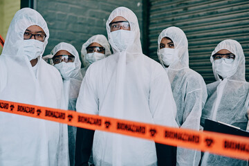 Covid, pandemic and team doctors, scientists or heathcare workers wearing protective ppe to prevent virus spread at a quarantine site. First responders wearing hazmat suits while standing behind tape - Powered by Adobe