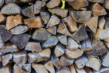 A pile of split wood outdoors.
