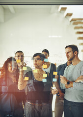 Young creative group in brainstorm, thinking and planning session in a modern office. Team sharing ideas and strategy for collaboration at the workplace. Designers in project plan meeting on glass. © Cecilie S W/peopleimages.com