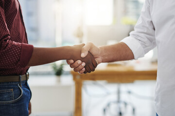 Handshake, agreement and meeting of business people in the office after a good deal. Closeup of diverse corporate employees greeting at the workplace in unity, support and trust