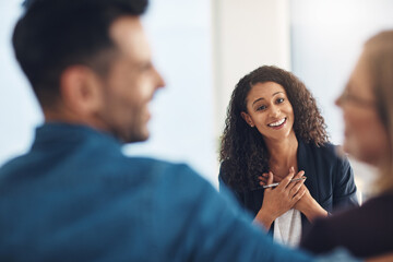 Smiling psychologist looking happy, cheerful and successful after counseling a couple in routine marriage therapy in a clinic. Proud mental healthcare professional watching and admiring after helping