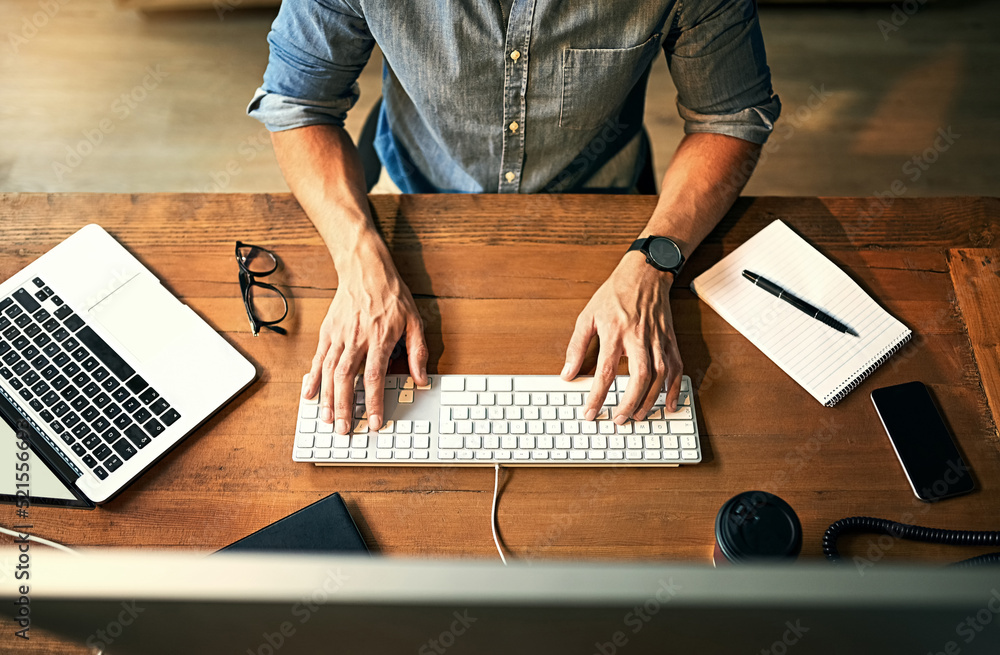 Poster Busy businessman typing on computer keyboard with hands late at night while working, planning and checking email at an office desk job. Productive corporate worker using latest technology