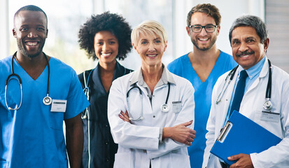 Team or group of a doctor, nurse and medical professional colleagues or coworkers standing in a hospital together. Portrait of diverse healthcare workers looking confident and happy about medicine - Powered by Adobe