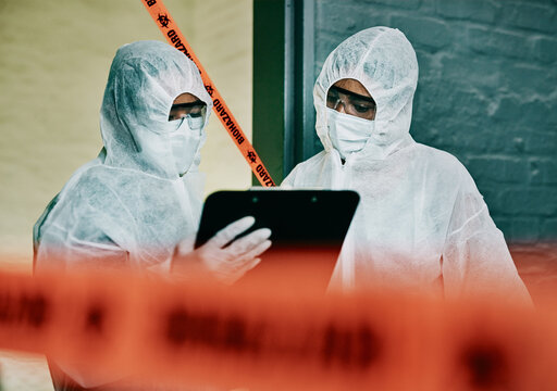 Covid, corona virus and outbreak healthcare workers inspecting contamination on site with red tape, protective mask and clipboard. Medical doctor or scientist working together during pandemic crisis