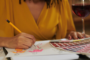 Closeup image of fashion designer working on color palette for new collection