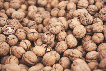 A view of a large pile of walnuts, on display at a local farmers market.