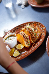 A view of a plate of beef birria tacos.