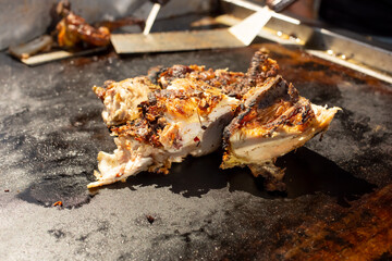 A view of a cook grilling pollo asado.