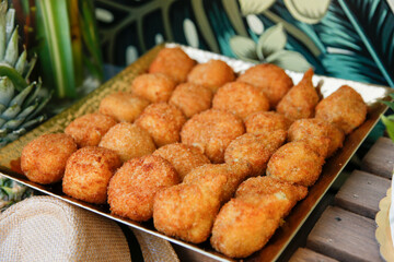 A view of a plate of croquettes, seen at a catered event.