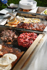 A view of the ingredient contents of a taco cart.