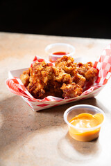 A view of a basket of deep fried alligator bites.