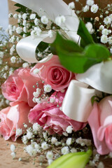 A closeup view of a bouquet of pink roses.