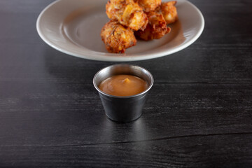 A view of a condiment cup of chili garlic aioli sauce.