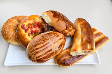 Turkish pastry product , tasty pogaca. Simit, gevrek. Turkish Pastries; peynirli, patatesli, kasarli pogaca, borek, acma, ay coregi at patisserie showcase.