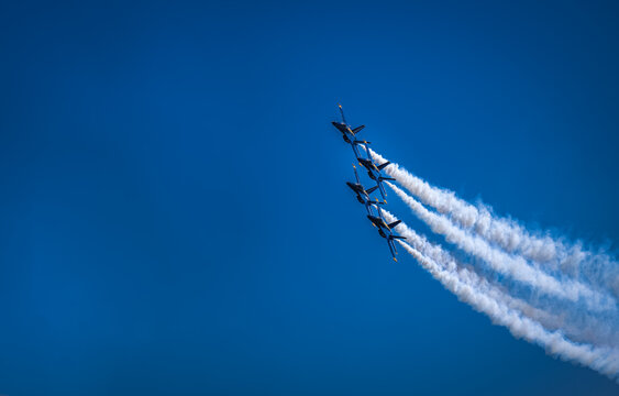 2022-08-06 FOUR BLUE ANGLE JETS FLYING OVER MERCER ISLAND WITH SMOKE TRAILING THE JETS AND A BLUE SKY DURING THE RETURN OF SEA FAIR EVENTS IN SEATTLE WASHINGTON