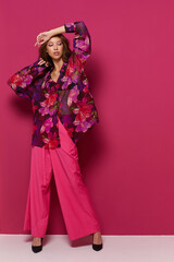 Young asian woman in blouse and pink pants.