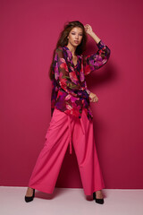 Young asian woman in blouse and pink pants.