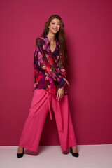 Young asian woman in blouse and pink pants.